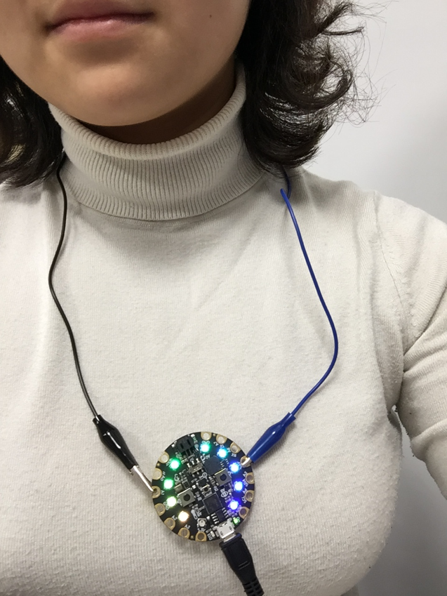 A woman wearing a circuit necklace with lights